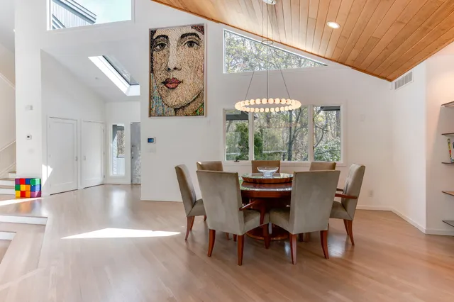 a view of a dining room with furniture and chandelier