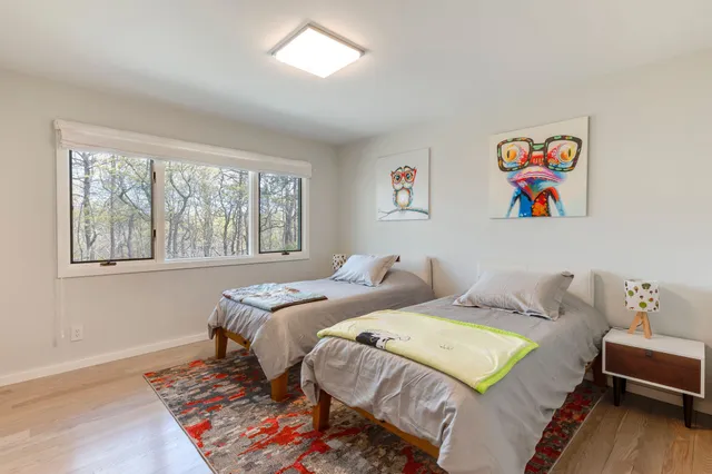 a bedroom with two beds and a couch