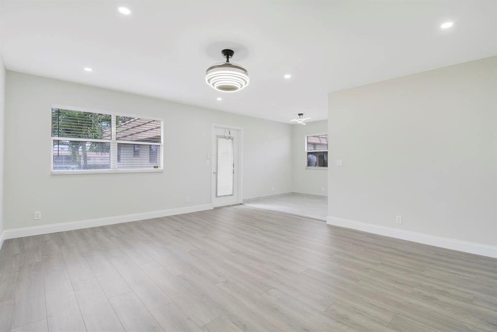 268 Saxony Circle, Unit 268 Delray Beach, FL 33446 - Photo 1 of 28 an empty room with wooden floor and windows