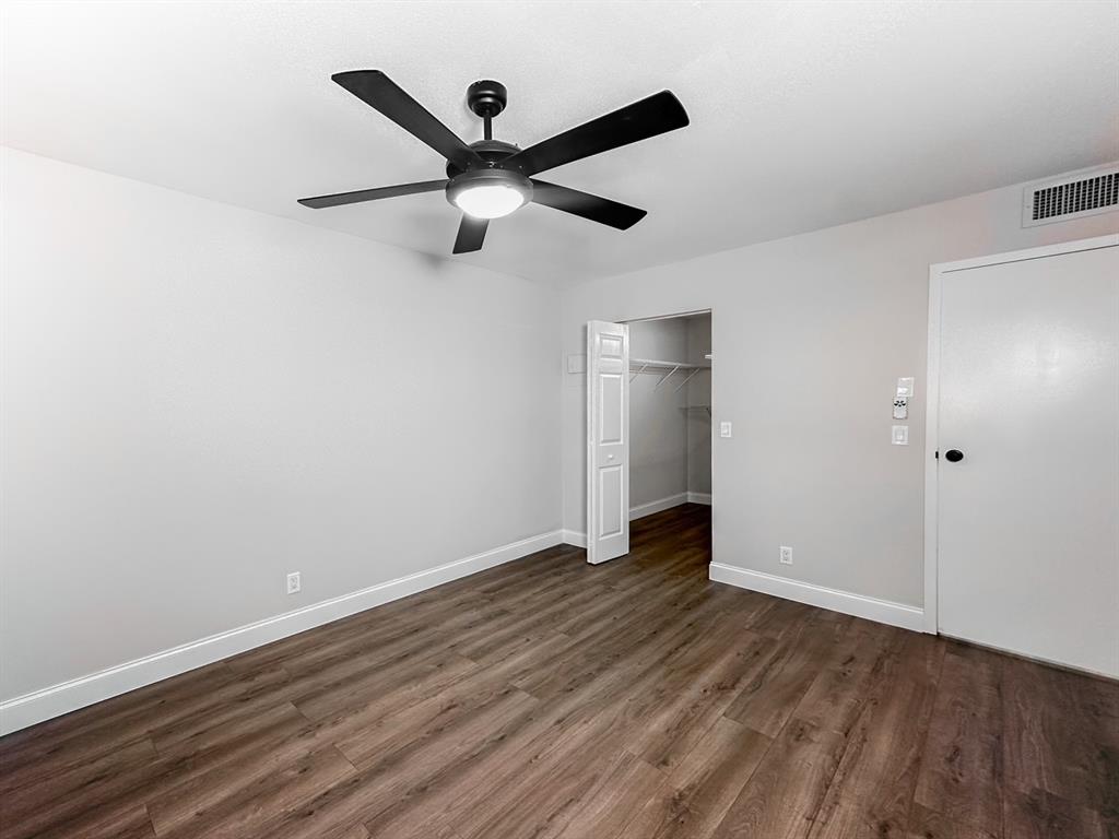 268 Saxony Circle, Unit 268 Delray Beach, FL 33446 - Photo 11 of 28 an empty room with wooden floor a ceiling fan and a window