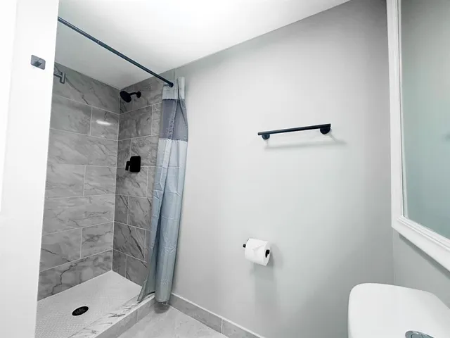 a bathroom with a sink toilet and mirror