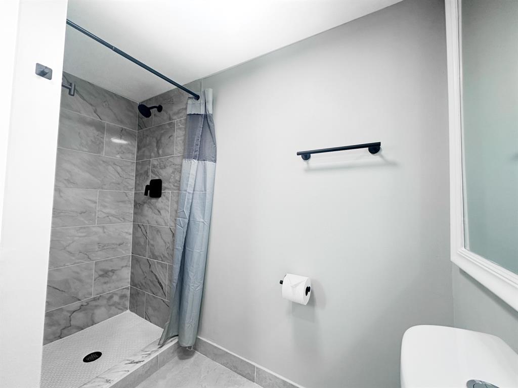 268 Saxony Circle, Unit 268 Delray Beach, FL 33446 - Photo 13 of 28 a bathroom with a shower and toilet