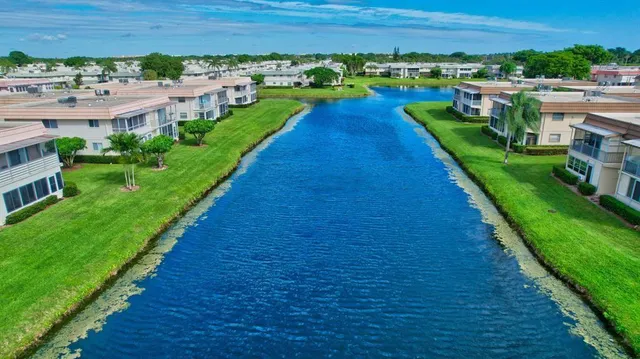 a view of a lake with houses in the back