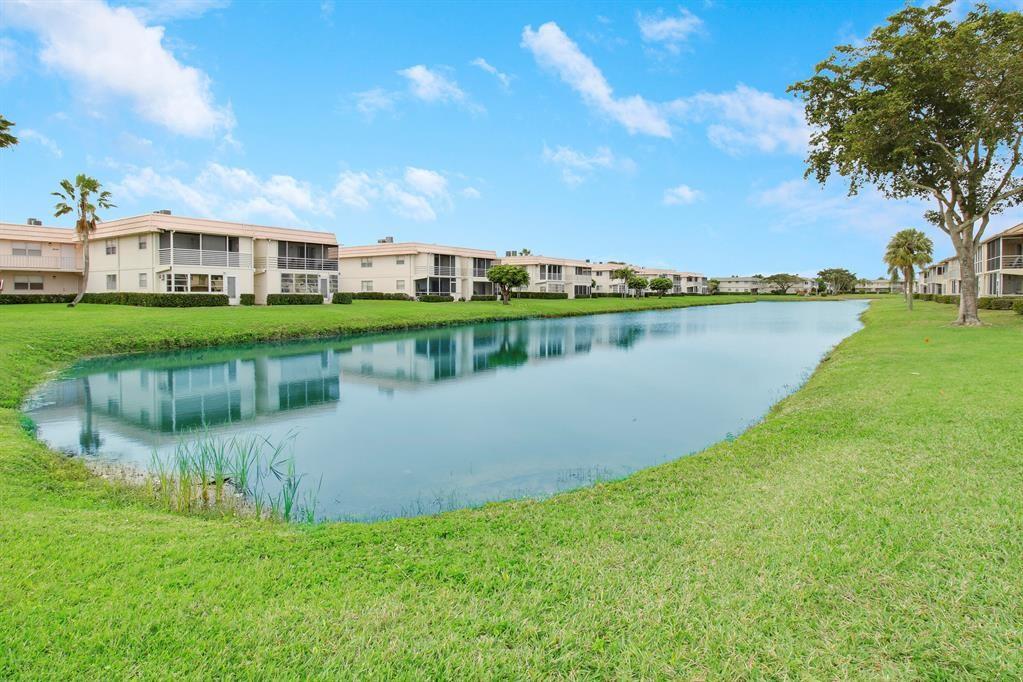 268 Saxony Circle, Unit 268 Delray Beach, FL 33446 - Photo 19 of 28 a view of a lake with houses in the back