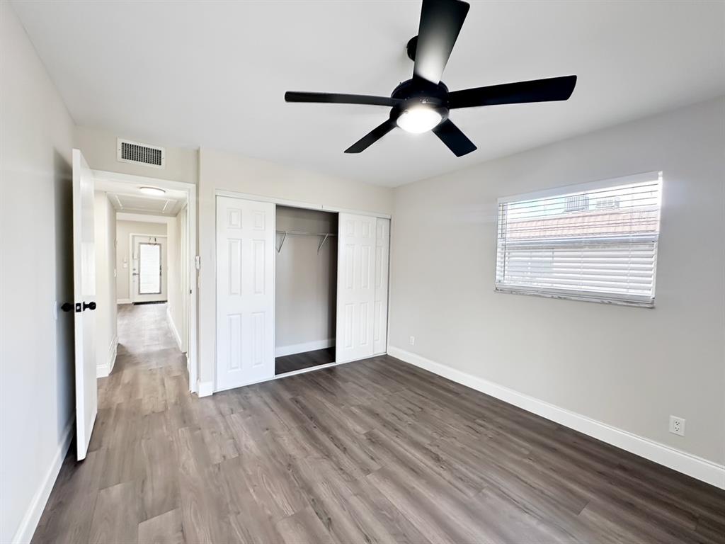 268 Saxony Circle, Unit 268 Delray Beach, FL 33446 - Photo 8 of 28 a view of an empty room with wooden floor and a window