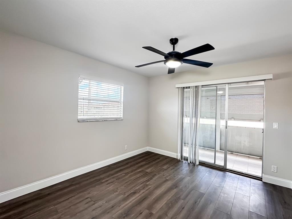 268 Saxony Circle, Unit 268 Delray Beach, FL 33446 - Photo 9 of 28 a view of an empty room with wooden floor and a window