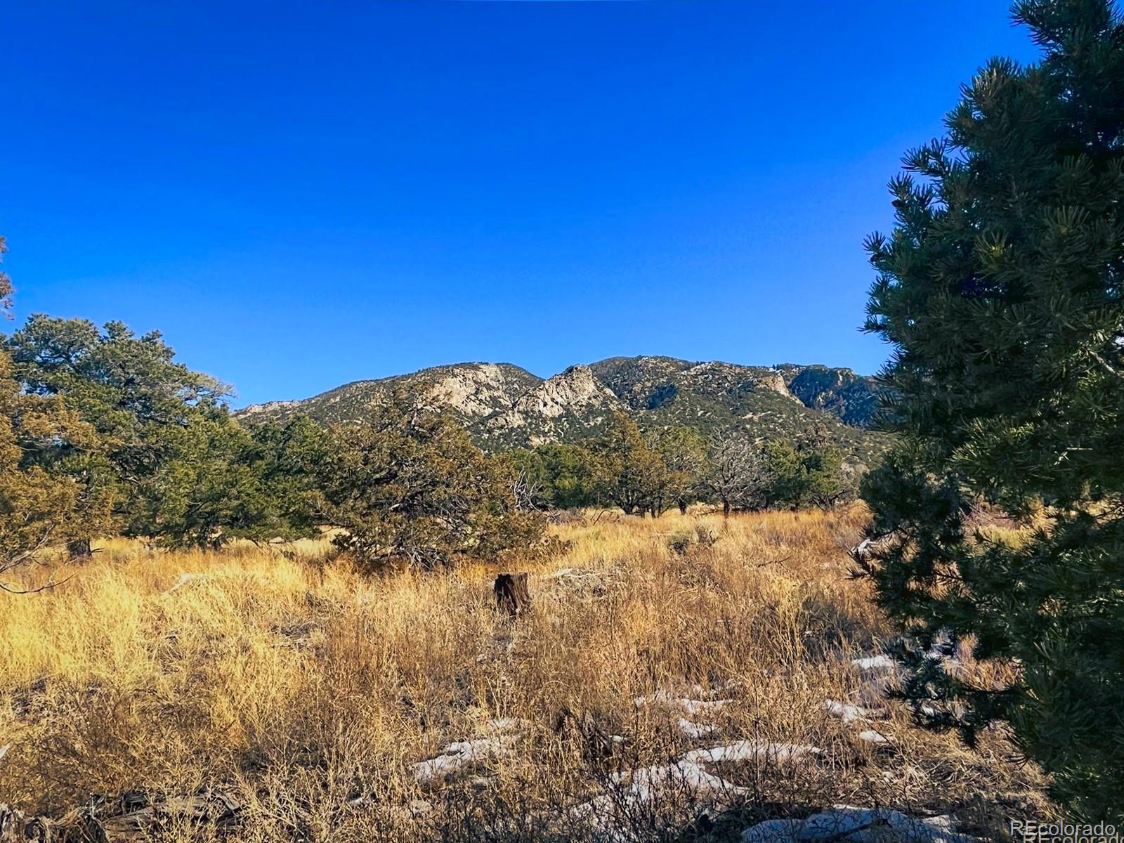 121 Cedar Ridge Road Mosca, CO 81146 - Photo 3 of 9 a view of mountain with lake in background
