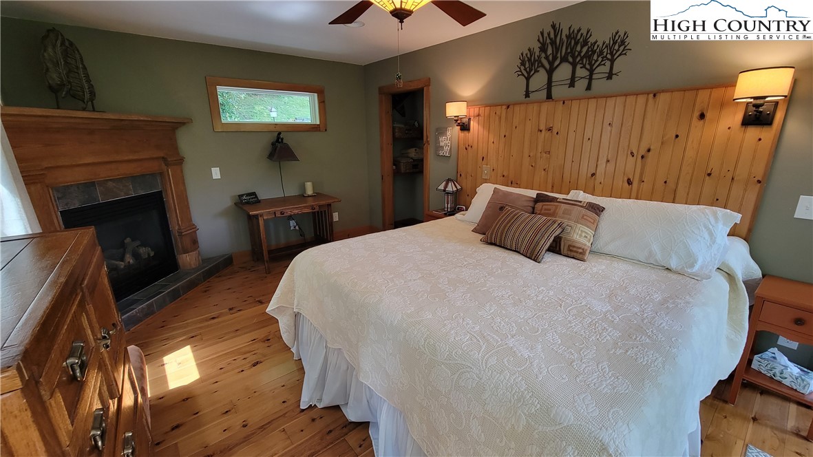 239 Wyndham Way Boone, NC 28607 - Photo 11 of 32 a bedroom with a bed and a chandelier