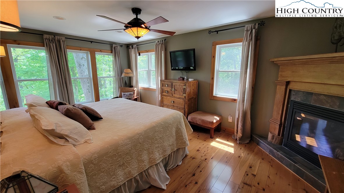 239 Wyndham Way Boone, NC 28607 - Photo 12 of 32 a bedroom with a bed and a flat tv screen on dresser
