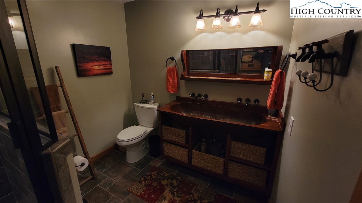 239 Wyndham Way Boone, NC 28607 - Photo 14 of 32 a bathroom with a toilet a sink and mirror
