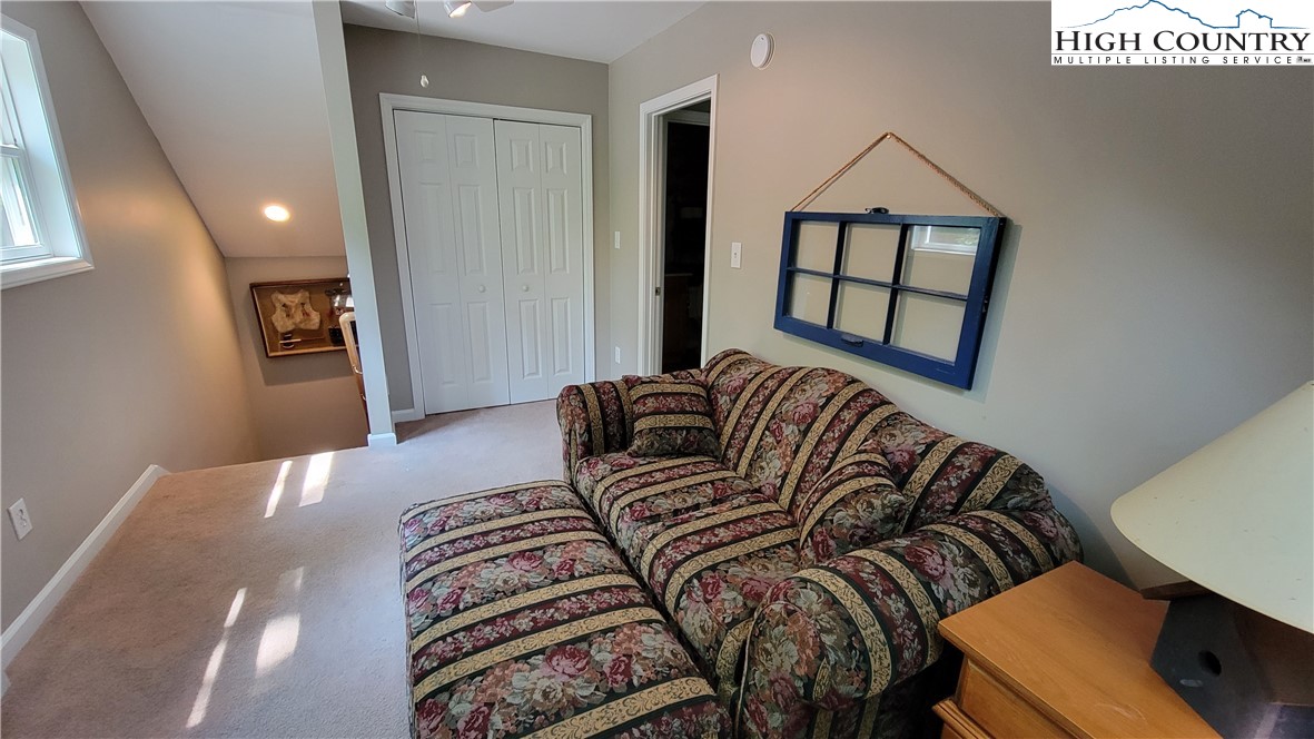 239 Wyndham Way Boone, NC 28607 - Photo 18 of 32 a bedroom with a bed and a dresser