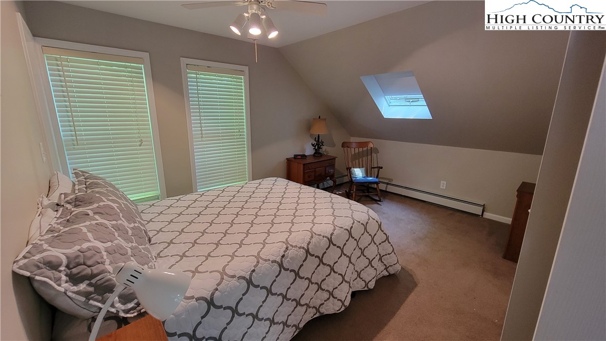 239 Wyndham Way Boone, NC 28607 - Photo 21 of 32 a bedroom with a bed and a window