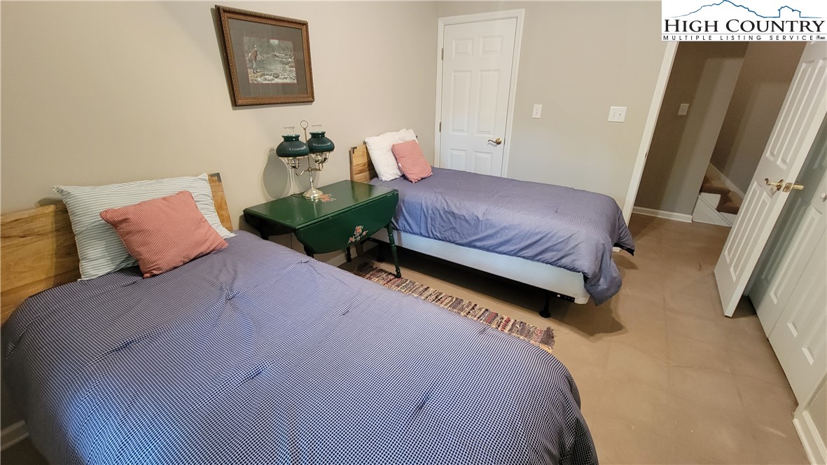 239 Wyndham Way Boone, NC 28607 - Photo 23 of 32 a bedroom with a bed and a couch