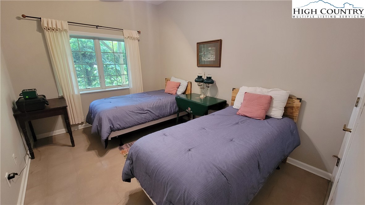 239 Wyndham Way Boone, NC 28607 - Photo 24 of 32 a bedroom with two beds and a window