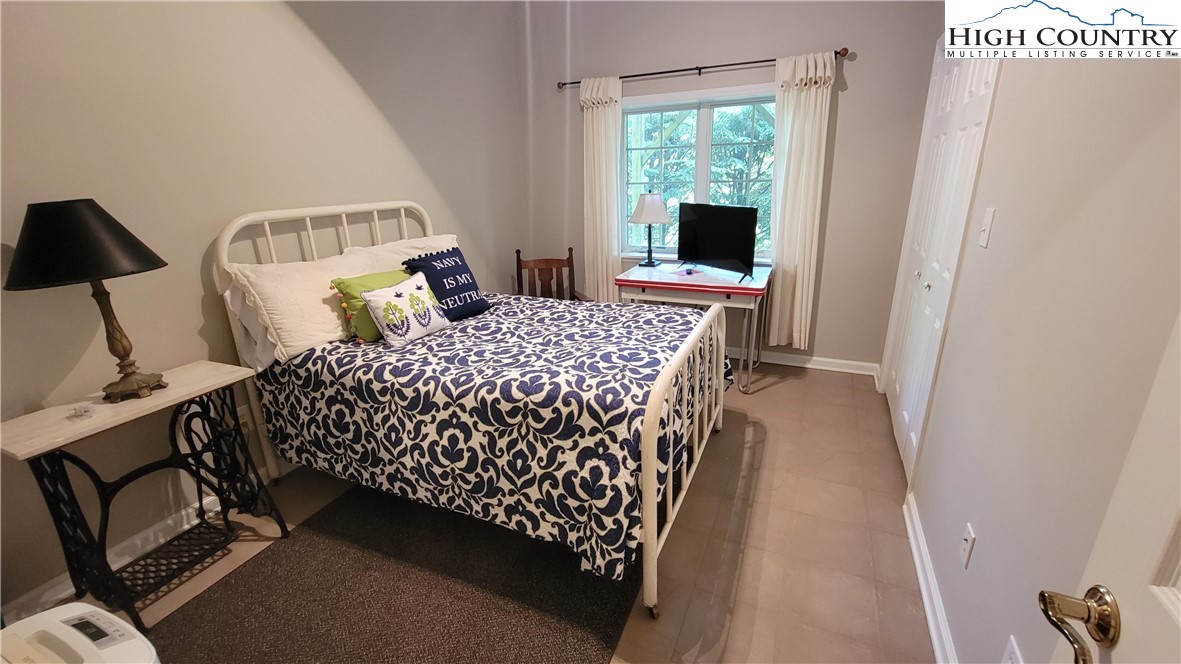 239 Wyndham Way Boone, NC 28607 - Photo 25 of 32 a bedroom with a bed and a window
