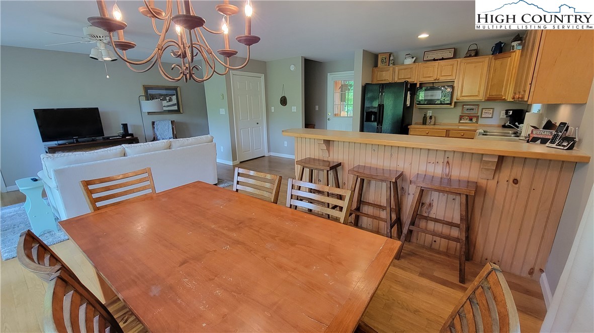 239 Wyndham Way Boone, NC 28607 - Photo 8 of 32 a dining room with furniture and a flat screen tv