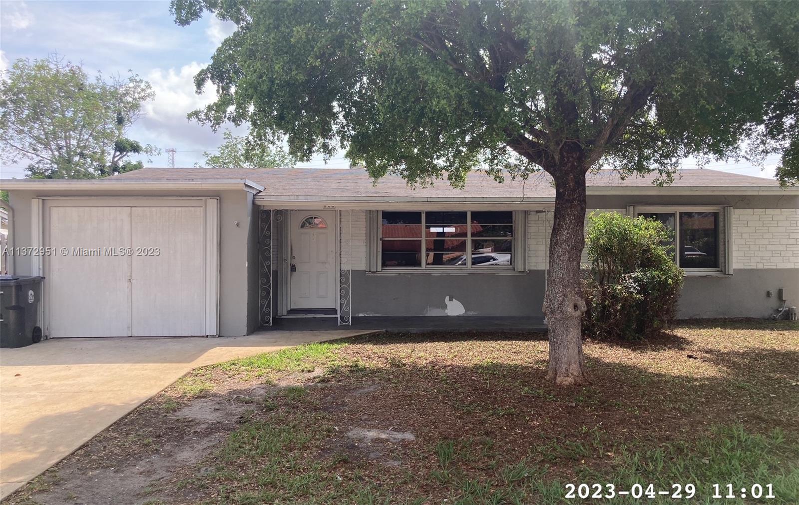106 Engle Road Lake Worth, FL 33461 - Photo 1 of 10 front view of a house with a tree in the yard