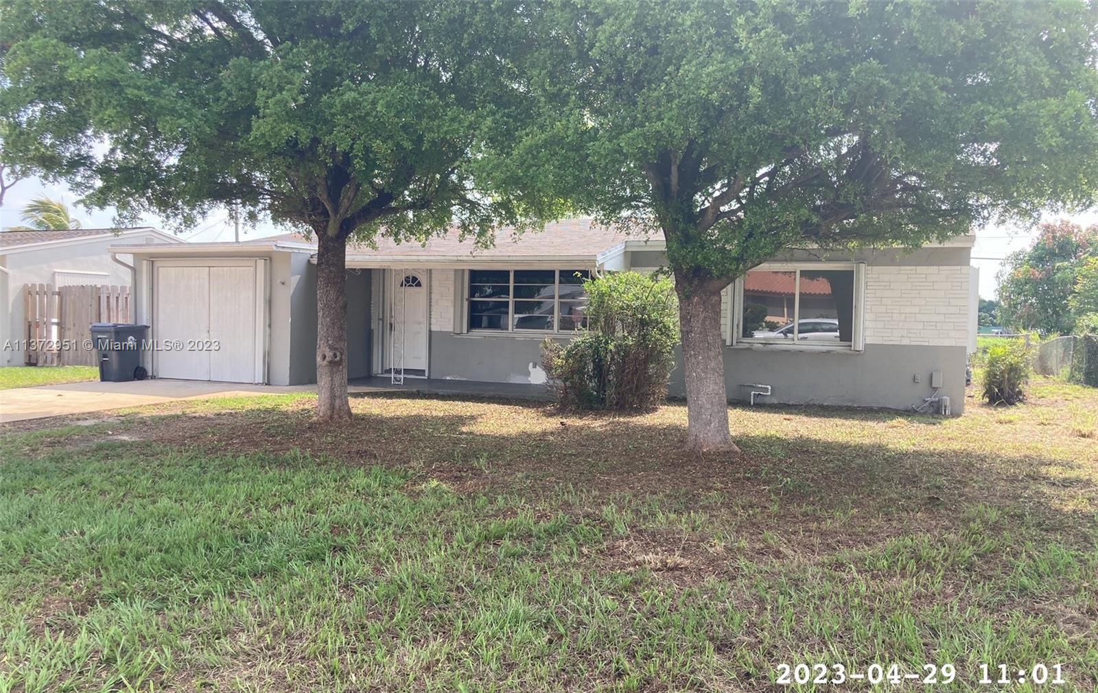 106 Engle Road Lake Worth, FL 33461 - Photo 2 of 10 a view of a house with a yard and large tree