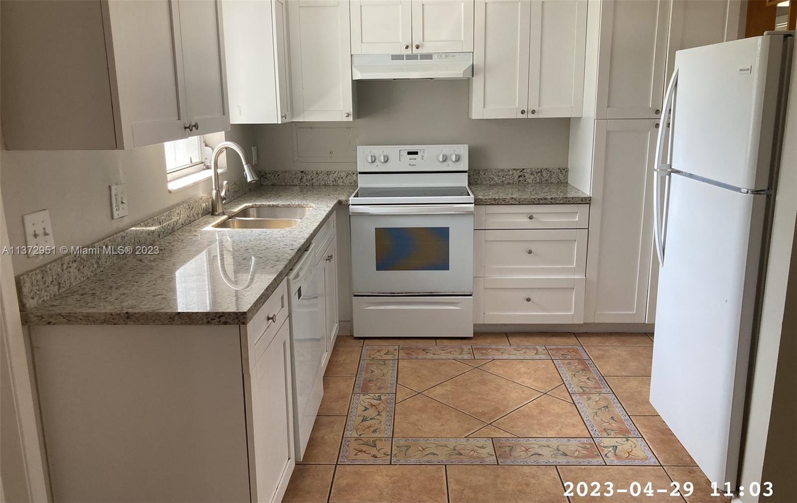 106 Engle Road Lake Worth, FL 33461 - Photo 4 of 10 a kitchen with granite countertop a sink stove and refrigerator