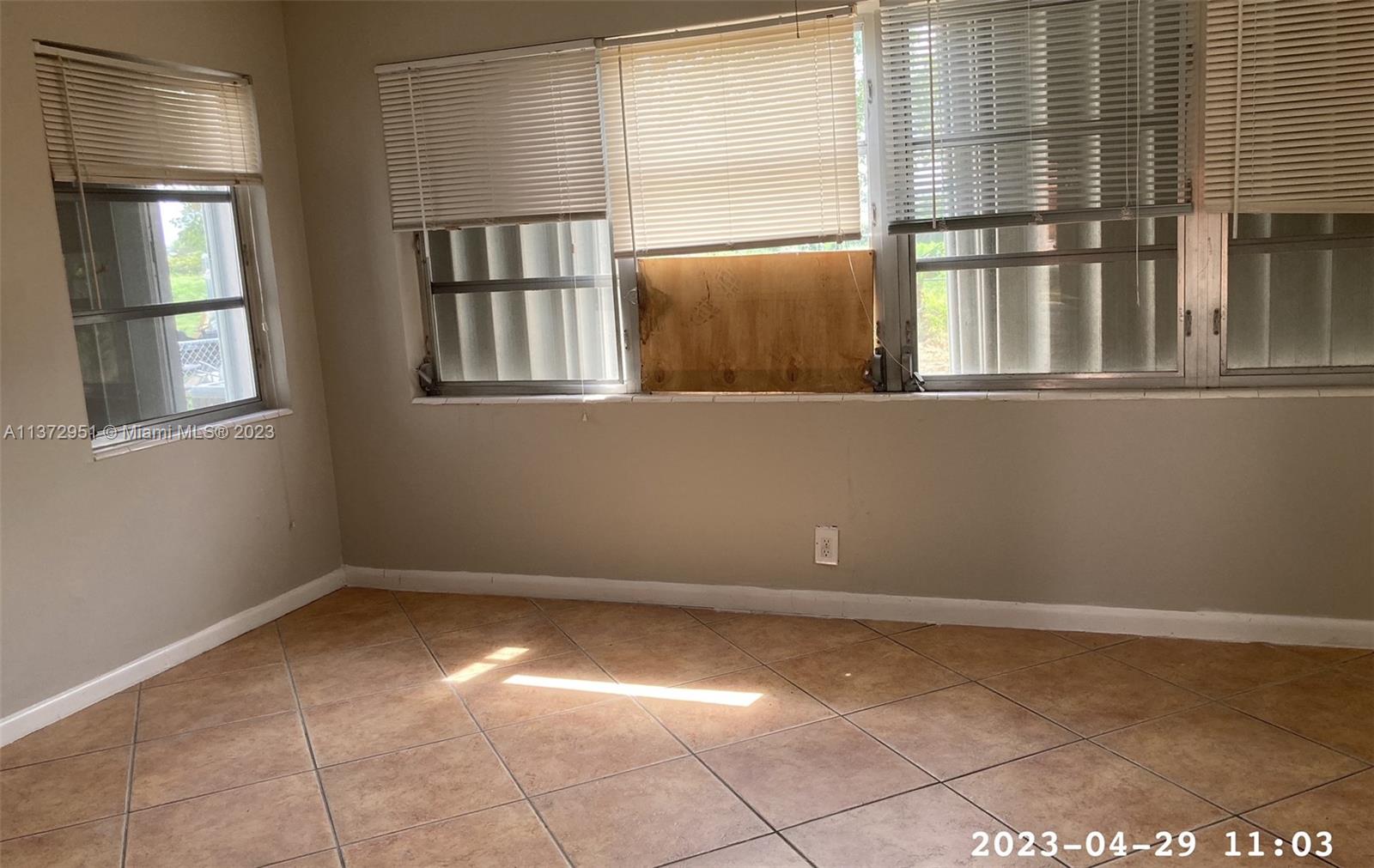 106 Engle Road Lake Worth, FL 33461 - Photo 5 of 10 a view of an empty room with a window