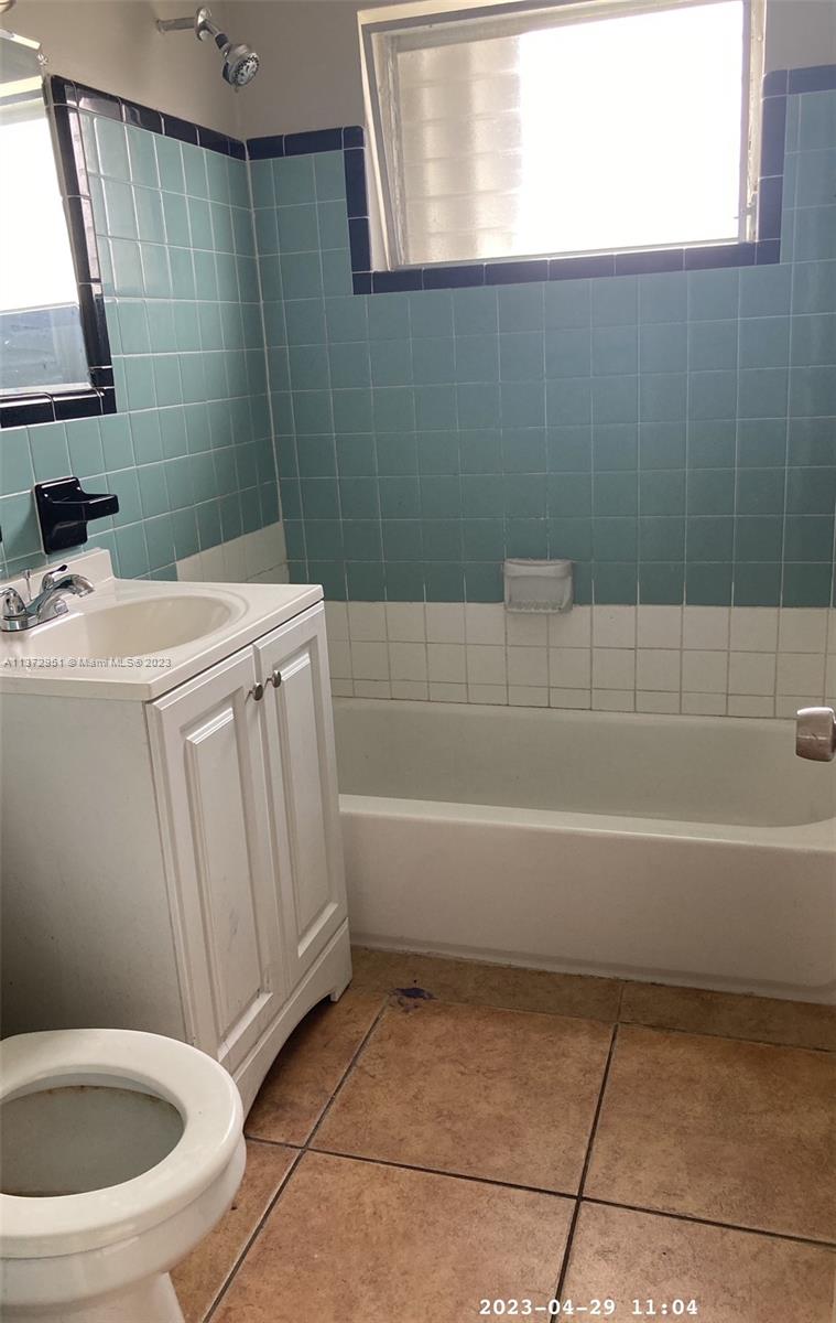106 Engle Road Lake Worth, FL 33461 - Photo 9 of 10 a bathroom with a sink a toilet and a bathtub