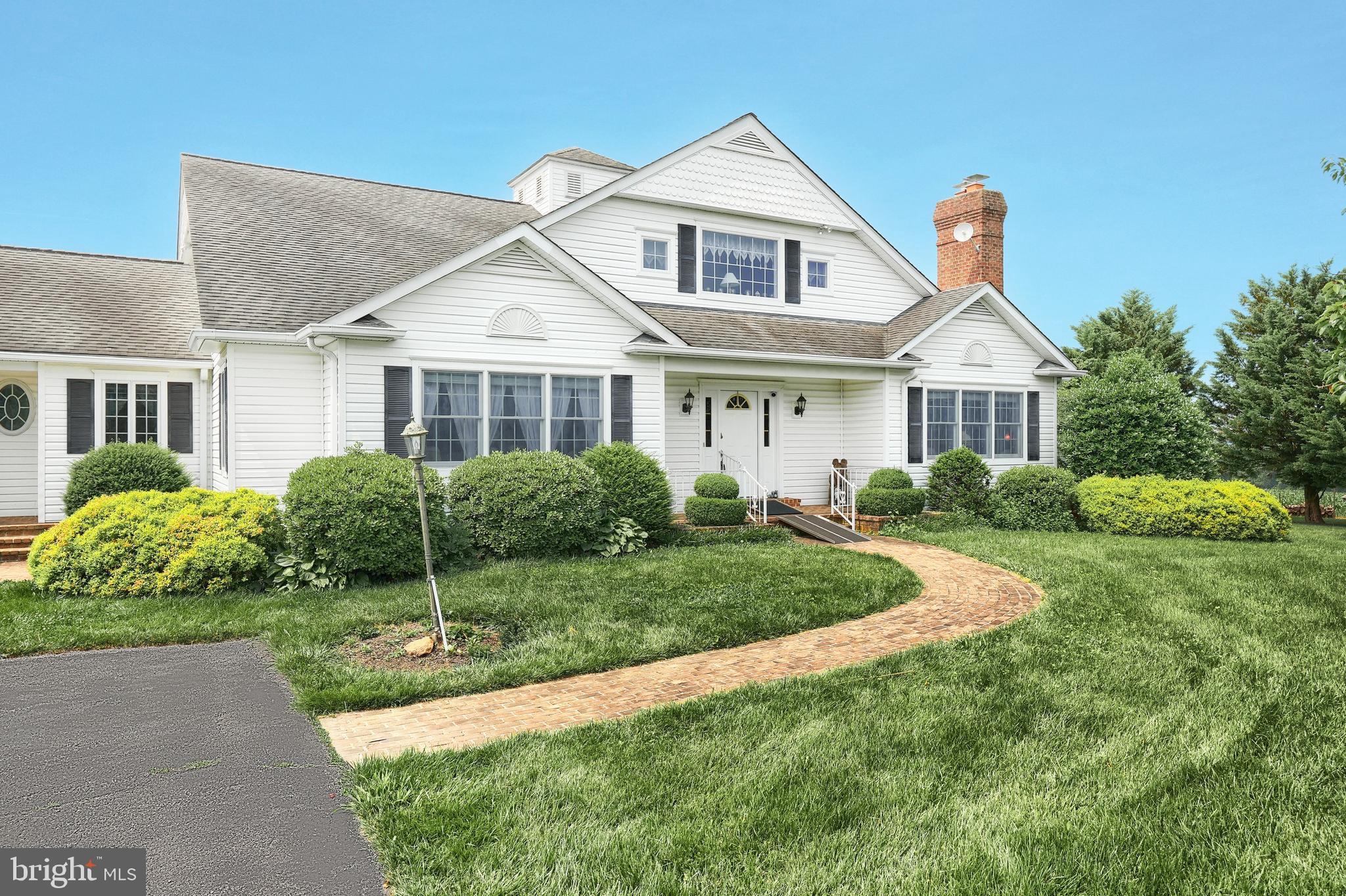 2700 Stockton Road Phoenix, MD 21131 - Photo 11 of 84 a front view of a house with a yard and potted plants