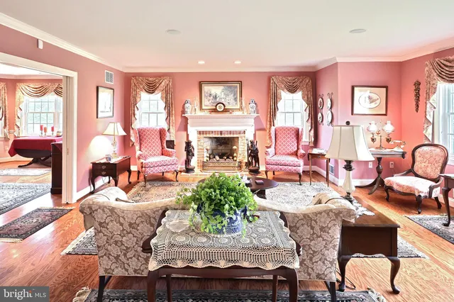 a bathroom with a sink and a large mirror next to a window