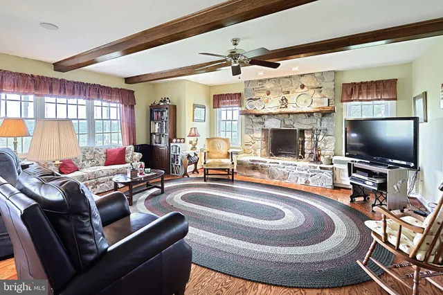 a living room with furniture a rug and a chandelier