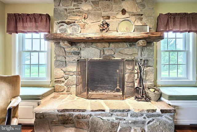 a bedroom with a bed a table and painting on the wall