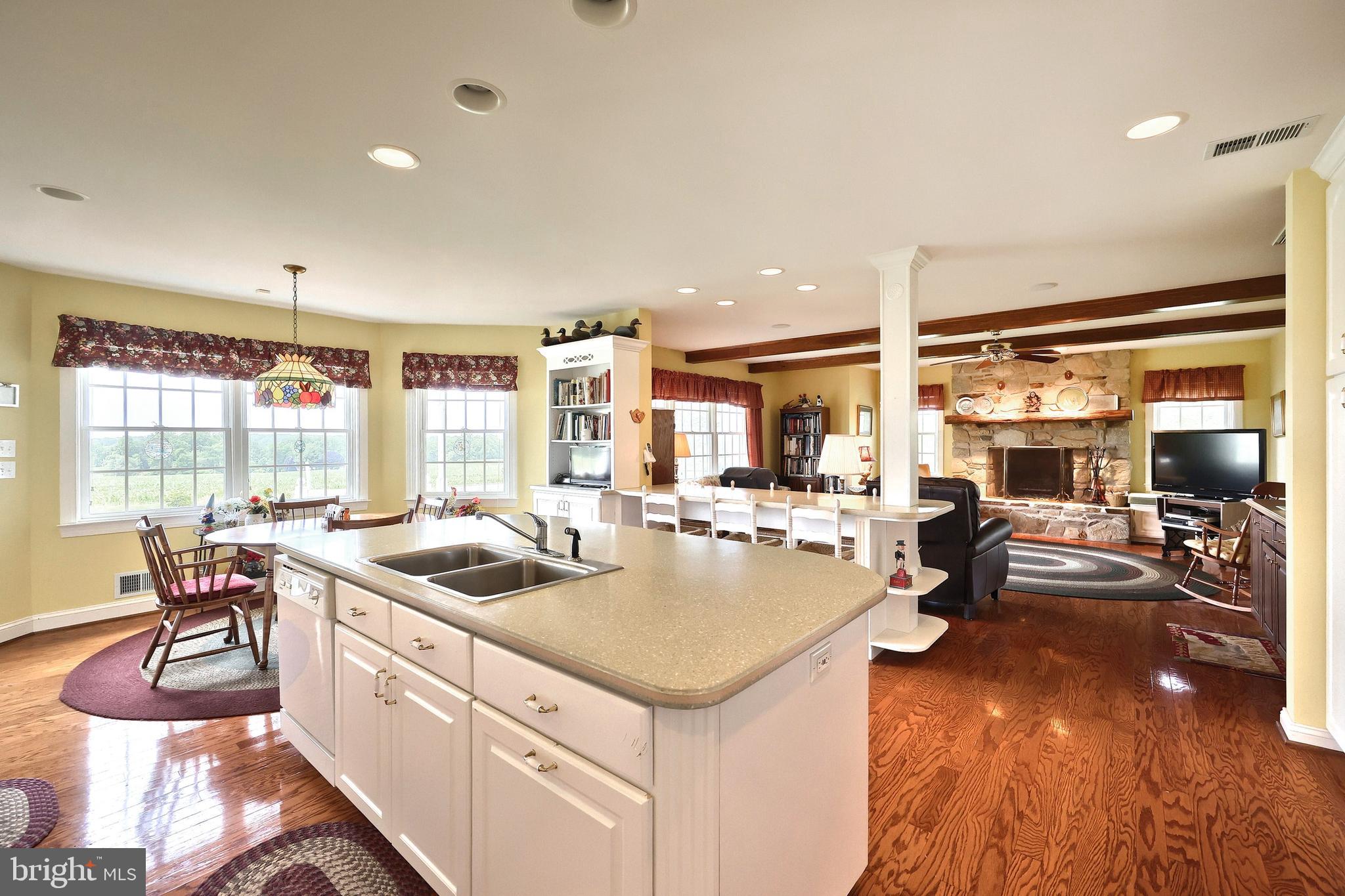 2700 Stockton Road Phoenix, MD 21131 - Photo 33 of 84 a kitchen with counter top space and dining table wooden floor
