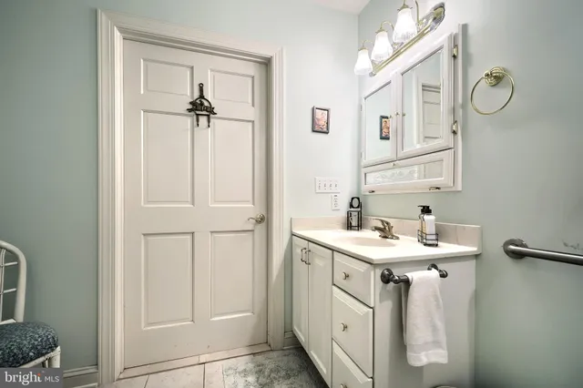 a bath room with a sink a toilet and a mirror