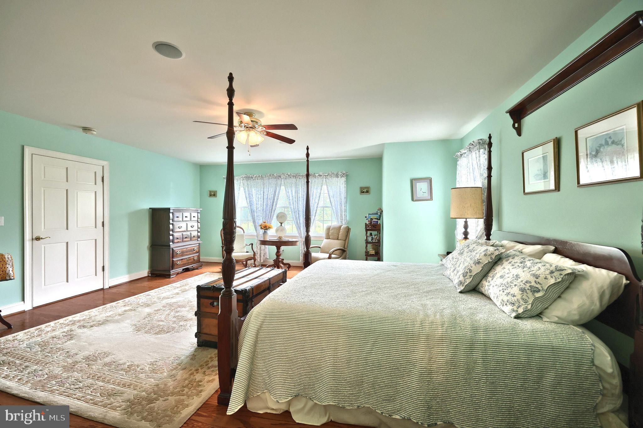 2700 Stockton Road Phoenix, MD 21131 - Photo 46 of 84 a bedroom with a bed a table and painting on the wall