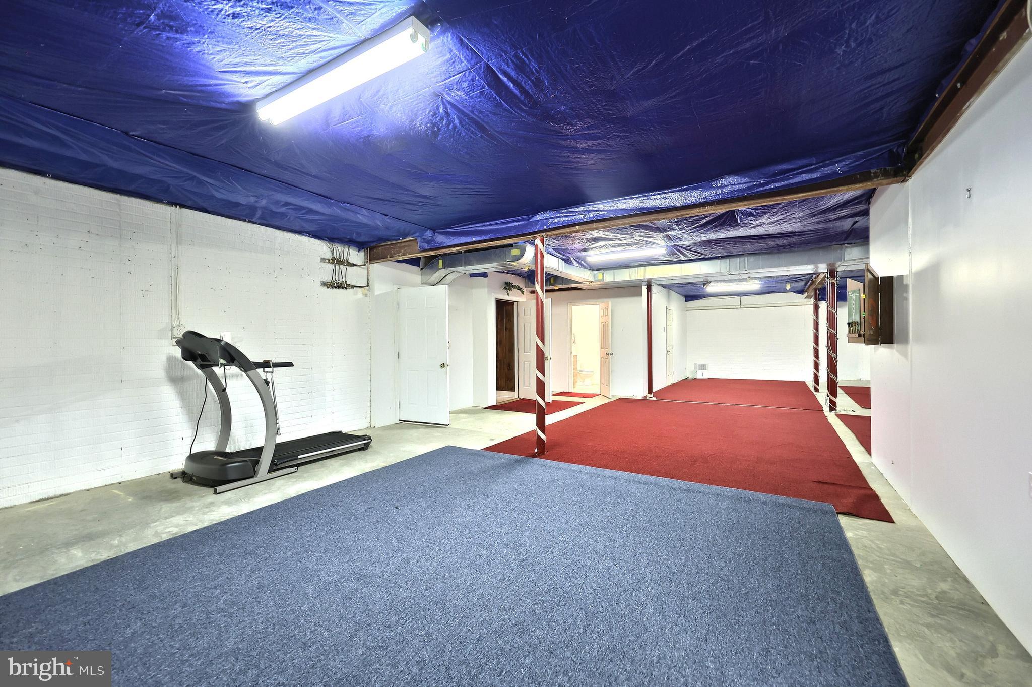 2700 Stockton Road Phoenix, MD 21131 - Photo 65 of 84 a room with gym equipment and a mirror