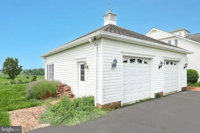 an aerial view of a house with pool garden and a yard