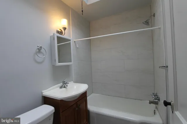 a bathroom with a sink toilet and bathtub