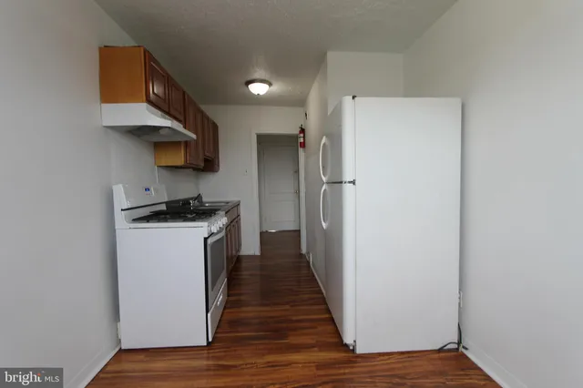 a kitchen with a refrigerator and a sink