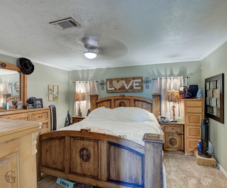 7229 Jennifer Lane Princeton, LA 71067 - Photo 11 of 15 a bedroom with a bed and a flat tv screen on the dresser