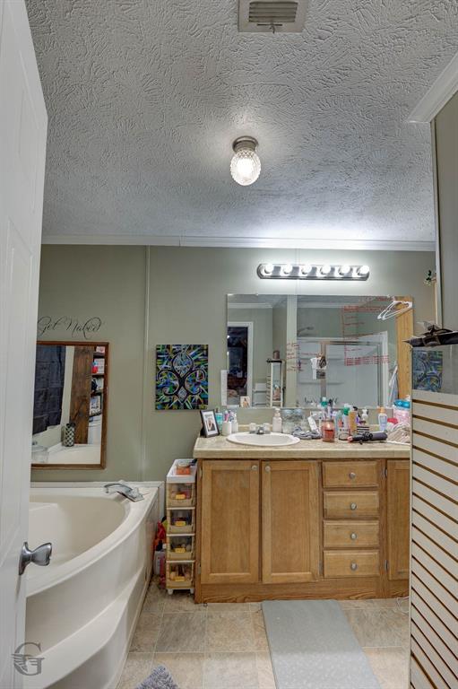 7229 Jennifer Lane Princeton, LA 71067 - Photo 13 of 15 a bathroom with a double vanity sink a mirror and bathtub