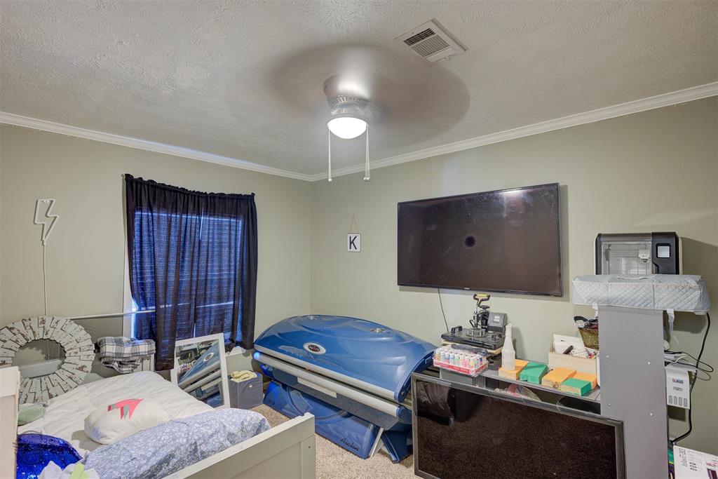 7229 Jennifer Lane Princeton, LA 71067 - Photo 14 of 15 a bedroom with a bed and a flat screen tv