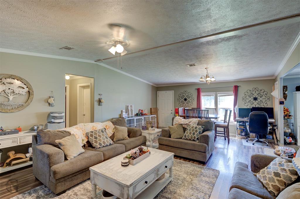 7229 Jennifer Lane Princeton, LA 71067 - Photo 4 of 15 a living room with furniture a fireplace and a chandelier