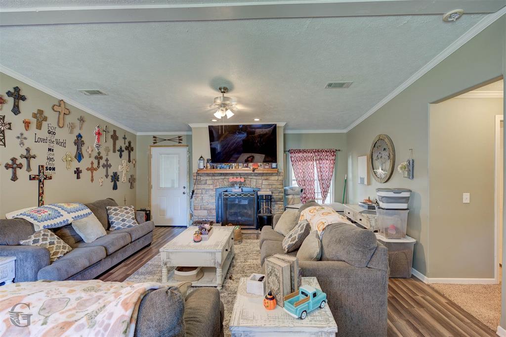 7229 Jennifer Lane Princeton, LA 71067 - Photo 5 of 15 a living room with furniture a fireplace and a flat screen tv