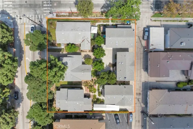 an aerial view of residential houses with outdoor space and street view