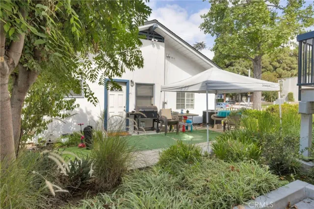 a view of a house with patio and garden