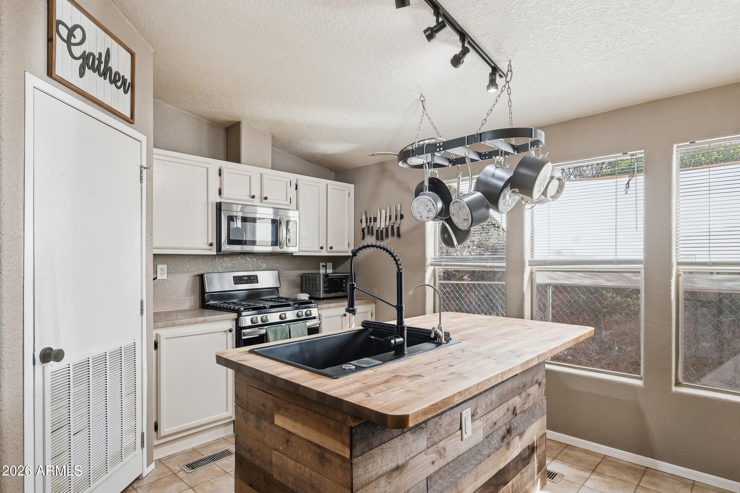 140 East Lariat Drive Payson, AZ 85541 - Photo 12 of 32 a kitchen with kitchen island a counter top space a sink cabinets and appliances