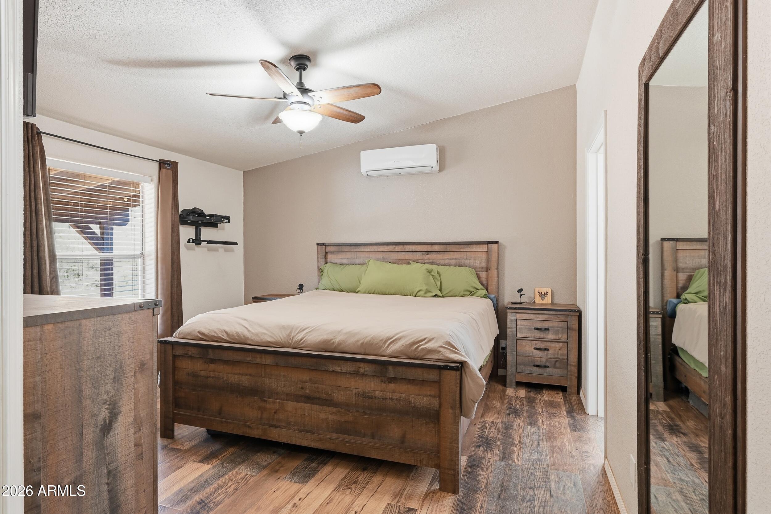 140 East Lariat Drive Payson, AZ 85541 - Photo 15 of 32 a bedroom with a bed and a chandelier