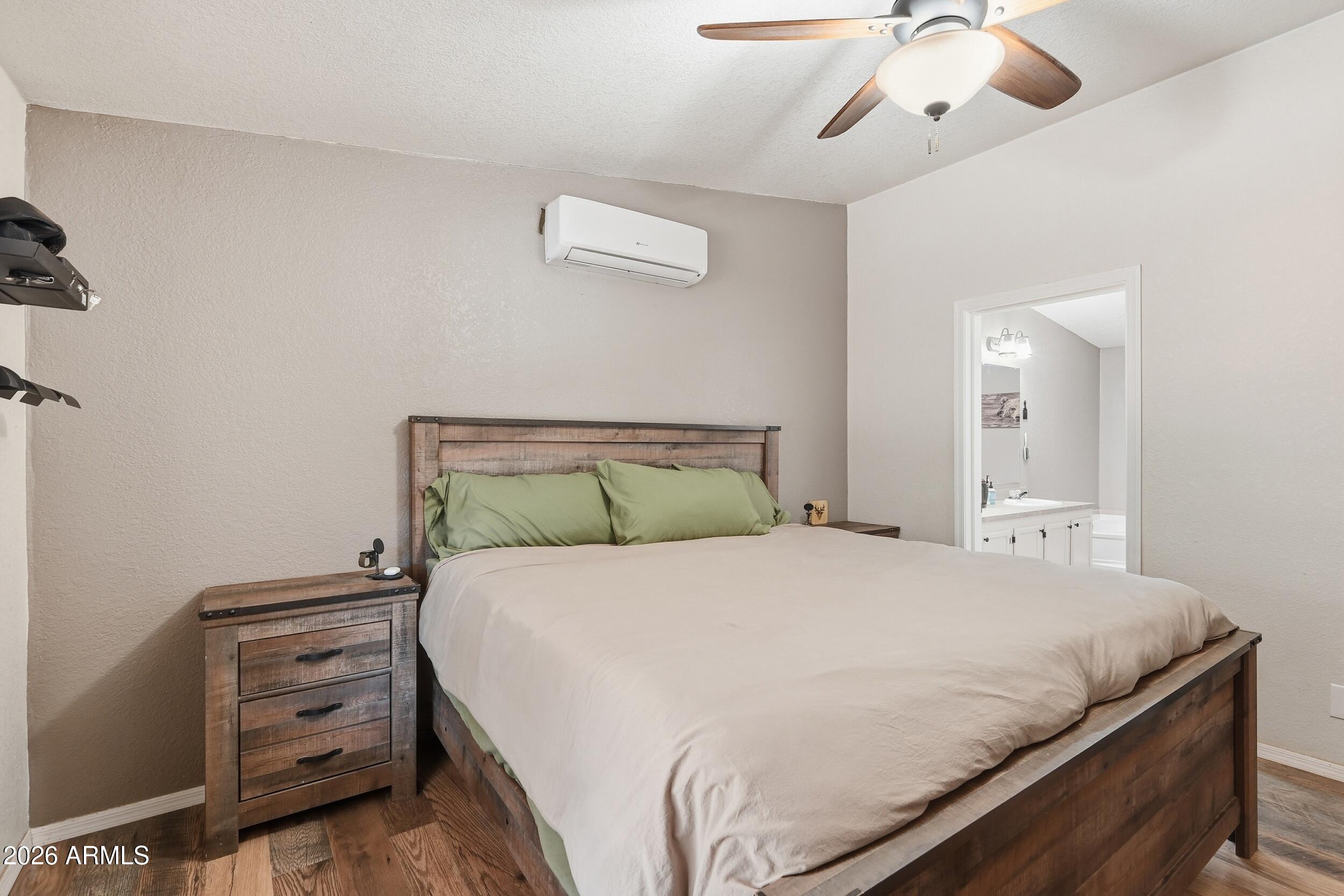 140 East Lariat Drive Payson, AZ 85541 - Photo 17 of 32 a bedroom with a bed and a chandelier