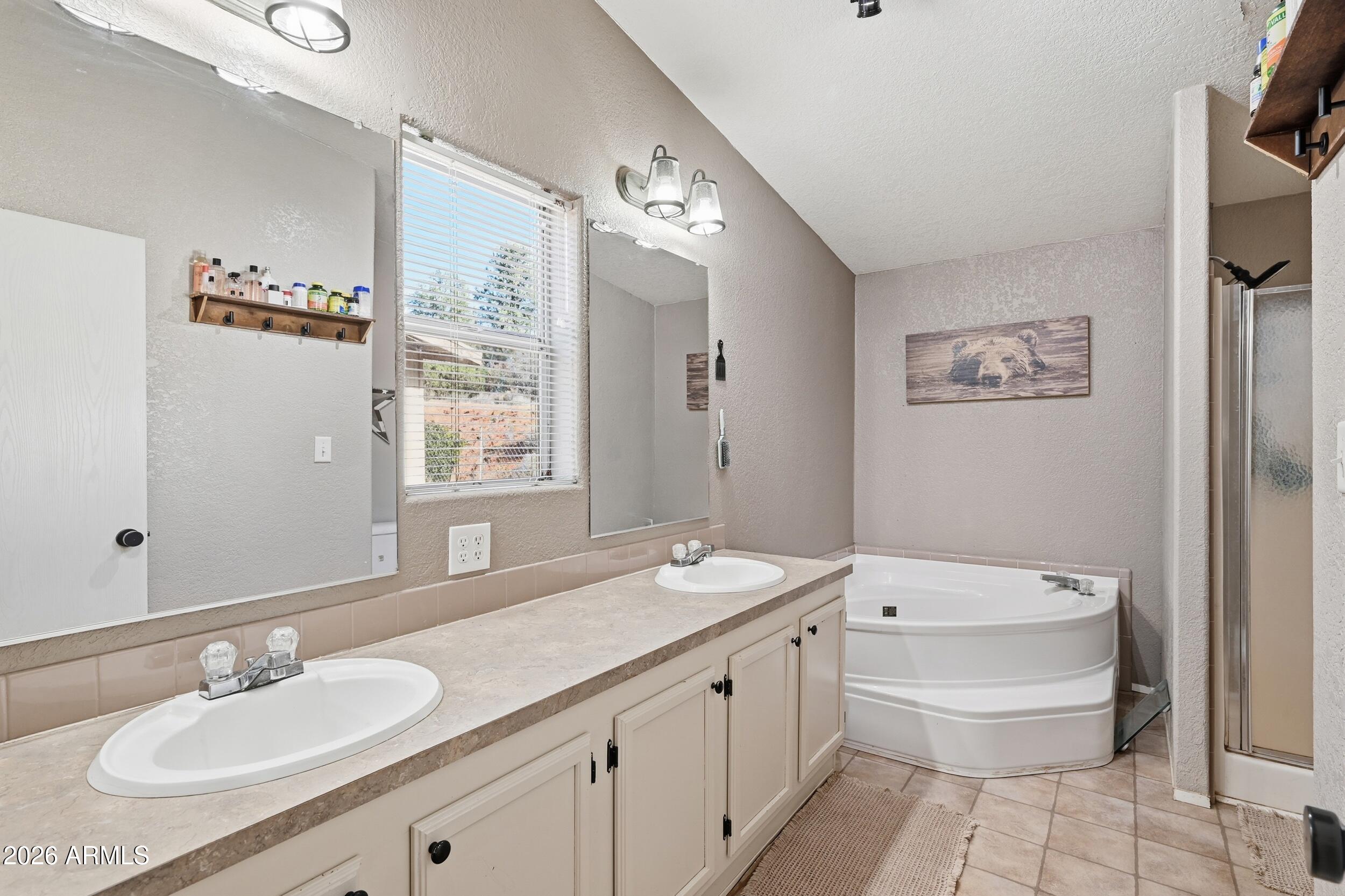140 East Lariat Drive Payson, AZ 85541 - Photo 18 of 32 a bathroom with a granite countertop sink a toilet a mirror and bathtub