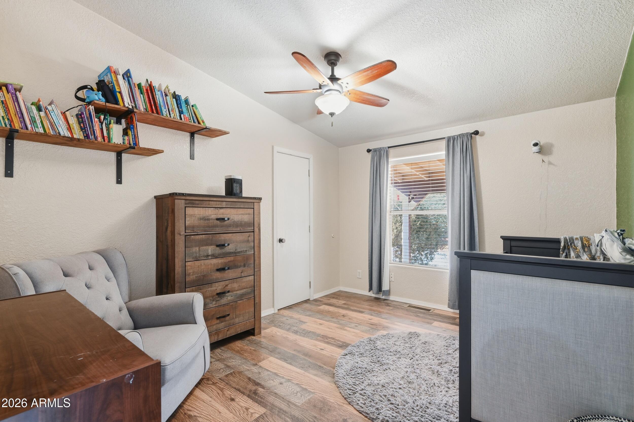 140 East Lariat Drive Payson, AZ 85541 - Photo 20 of 32 a bedroom with a bed and a chandelier