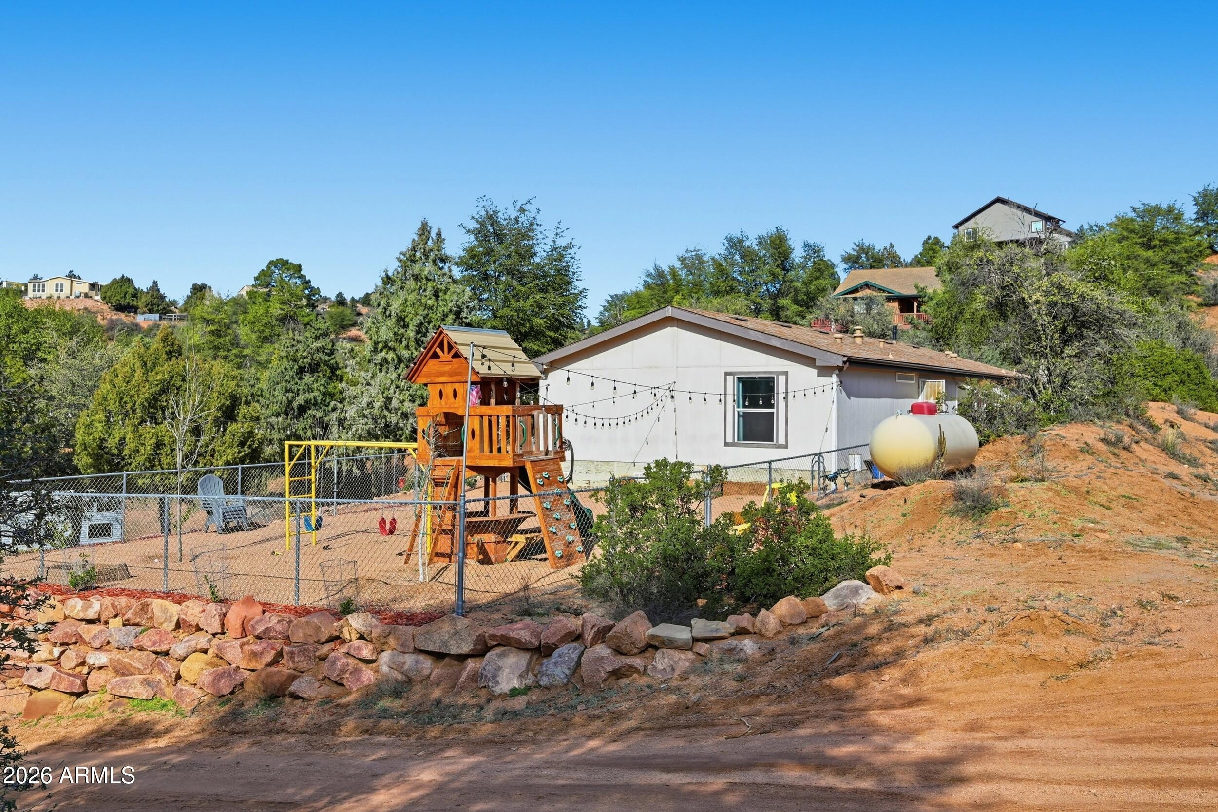 140 East Lariat Drive Payson, AZ 85541 - Photo 24 of 32 a view of a backyard with plants and a patio