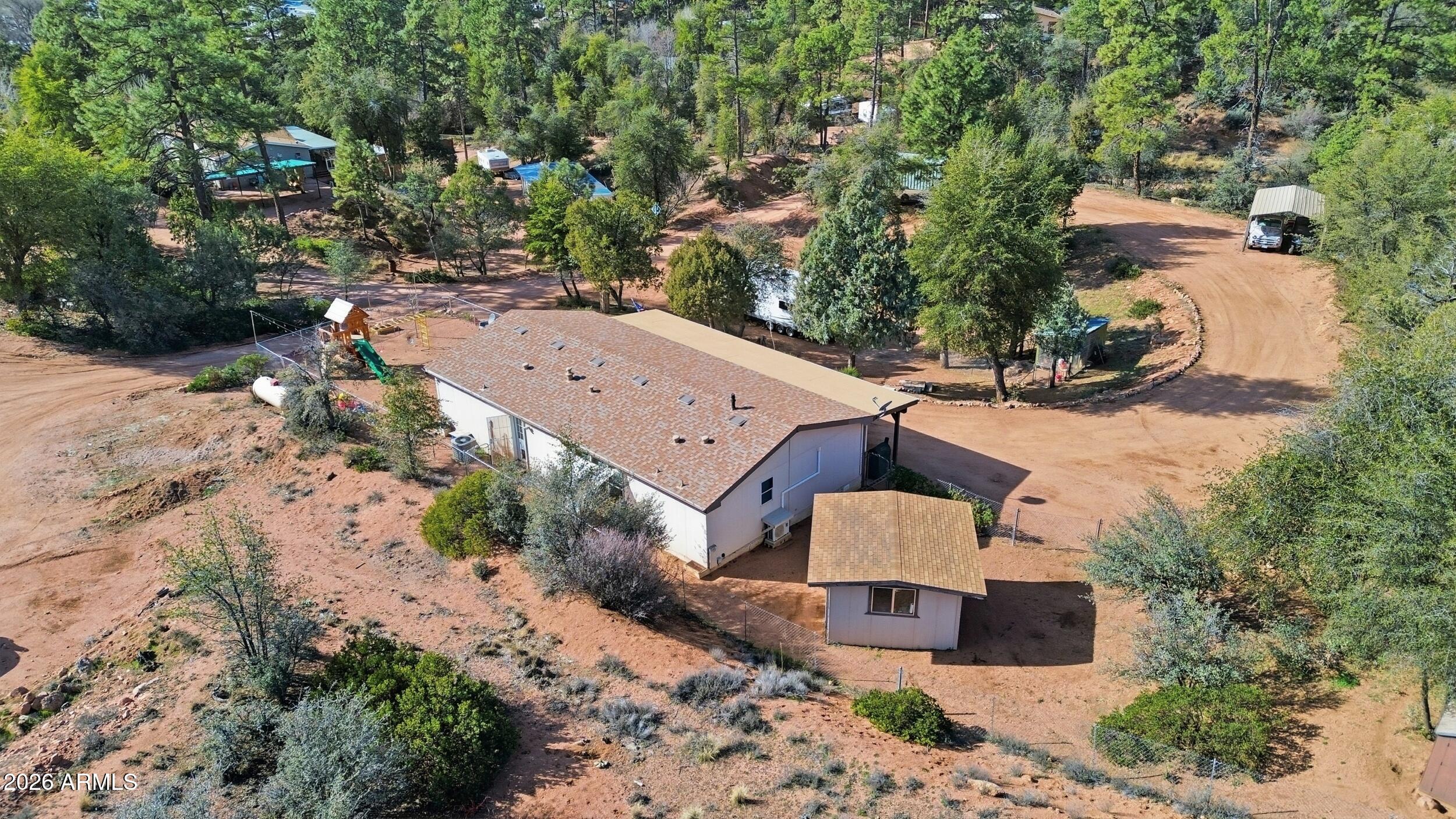 140 East Lariat Drive Payson, AZ 85541 - Photo 29 of 32 an aerial view of a house with a yard and a large tree
